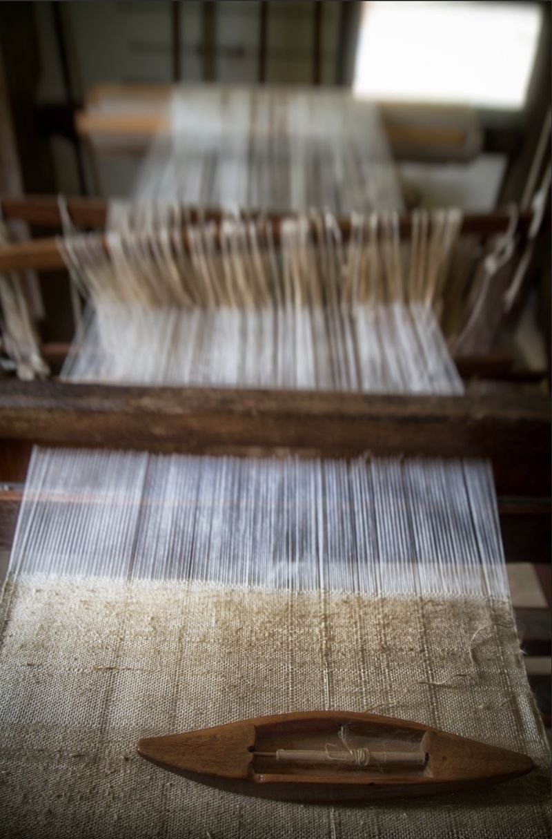 Loom with the warp set up and the shuttle on the fabric